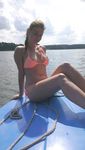 Young nudists rub oil on each other's naked bodies