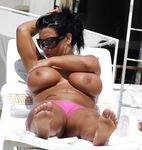 Adult nudist babe lights up at the beach