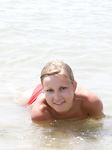 Adult nudist babe lights up at the beach