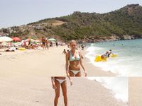 Topless on the Sand With a White Cloth and Beach Umbrellas