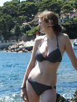 Topless on the Sand With a White Cloth and Beach Umbrellas