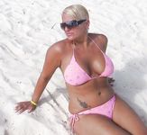 Topless on the Sand With a White Cloth and Beach Umbrellas