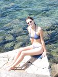 Topless on the Sand With a White Cloth and Beach Umbrellas