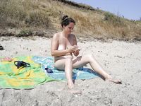 Adult naturist friends naked together at the beach