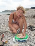 Adult naturist friends naked together at the beach