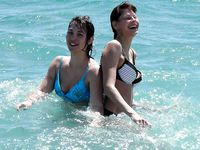 Adult naturist friends naked together at the beach