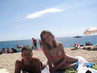 Adult naturist friends naked together at the beach