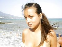 Topless Dancing on a Sunny Beach Full of Seaside Crowds