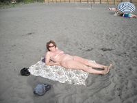 Topless Dancing on a Sunny Beach Full of Seaside Crowds
