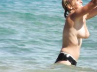 girl woman on the nude beach with big tits, but a big body, too.