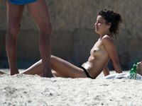 Hot babe sunbathes on nude beach