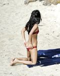 Two Women With Wet Hair Stand Together on a Sunny Beach