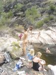 She Adjusts Her Striped Bikini Top on a Bright Sunny Beach