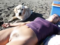 Two Women in Bikini Tops Strolling on a Topless Beach