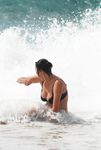 Kneeling and Smiling on a Sunny Nude Beach