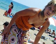 Two Nude Women Walk Together on a Sunlit Public Beach