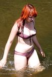 Two Nude Women Walk Together on a Sunlit Public Beach
