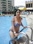 Topless Sunbathing With the Ocean Stretching Behind Her