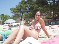 Topless Sunbathing With the Ocean Stretching Behind Her