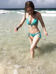 Topless Sunbathing With the Ocean Stretching Behind Her