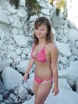 Topless Sunbathing With the Ocean Stretching Behind Her