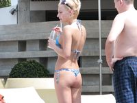 Topless Sunbathing With the Ocean Stretching Behind Her