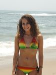 Topless Sunbathing With the Ocean Stretching Behind Her