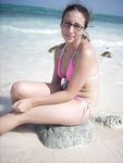 Topless Sunbathing With the Ocean Stretching Behind Her
