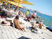 Her long hair barely covers her tits at the beach