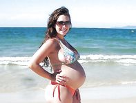 Her long hair barely covers her tits at the beach