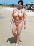 Nudist girls have fun with each other at the beach