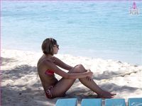 Nudist girls have fun with each other at the beach