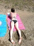 Sunlit Beach Afternoon for Three Relaxing Nudists
