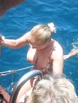 Sunlit Beach Afternoon for Three Relaxing Nudists