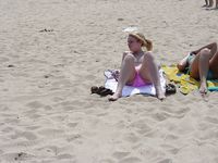 Sunlit Beach Afternoon for Three Relaxing Nudists