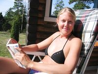 Two Women Lounge Topless in an Outdoor Pool