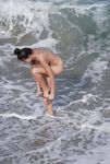 Castrated sissy at the nude beach