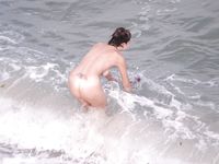 Castrated sissy at the nude beach