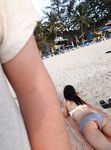 Laughing and Untying a Red Bikini Top on a Topless Beach