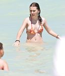 Two skinny nudist girls frolic around the beach