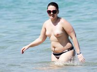 Two skinny nudist girls frolic around the beach