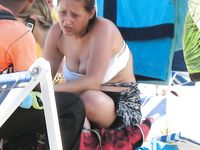 Two skinny nudist girls frolic around the beach