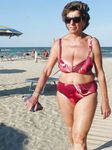Standing Topless in Shallow Beach Water on a Sunny Day