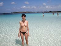 Having fun is easy at the beach for two nude teens