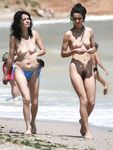 Holding a Paddle Racket on a Nude Beach Shoreline