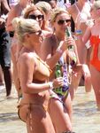 Adult naturists rub oil on each other's naked bodies