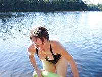 Adult naturists rub oil on each other's naked bodies