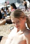 Adult naturists rub oil on each other's naked bodies