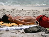 Adult adult naturist lays naked at the beach
