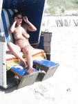Curvy adult bares all at a nudist beach in the sun